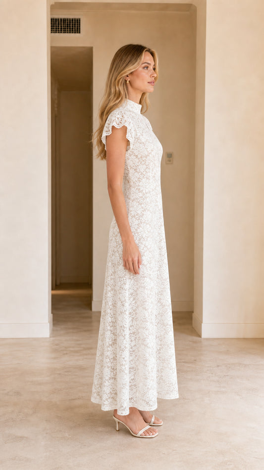 Side profile view of model in white flutter sleeve lace gown
