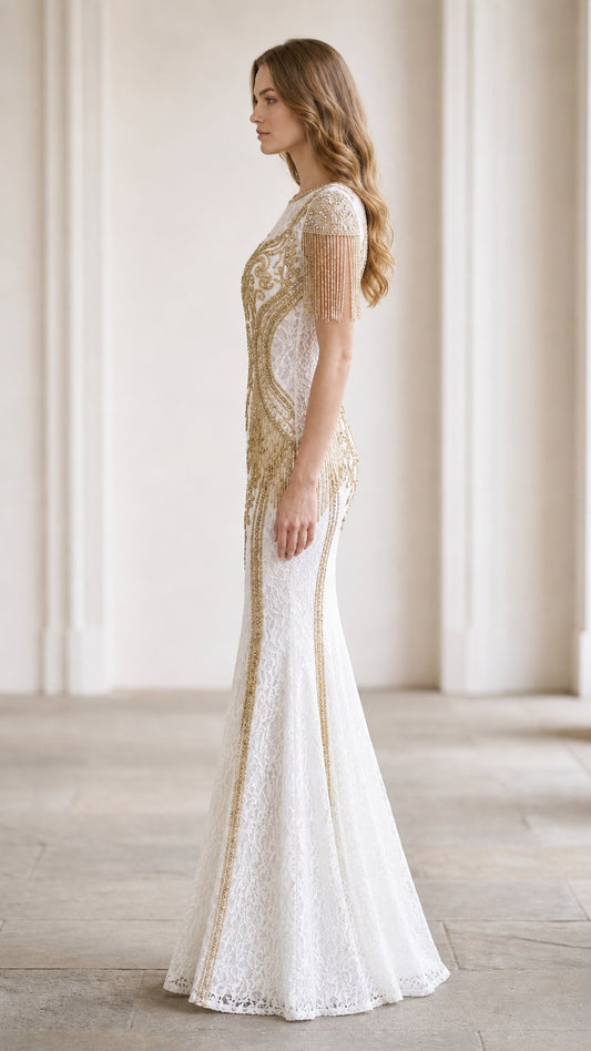 Side profile of white lace mermaid gown showing fitted silhouette and trailing beaded accents