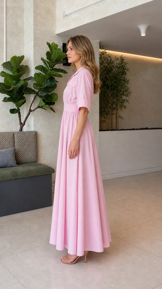 Side profile of woman wearing blush pink short sleeve pleated maxi dress