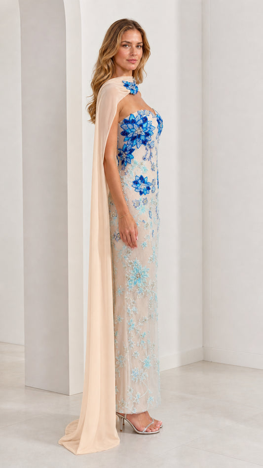 Side profile of champagne beaded sweetheart maxi dress with flowing shoulder drape