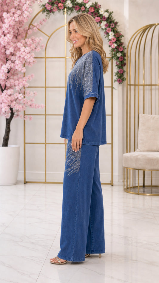 Side profile view of woman wearing denim blue two-piece embellished pant set