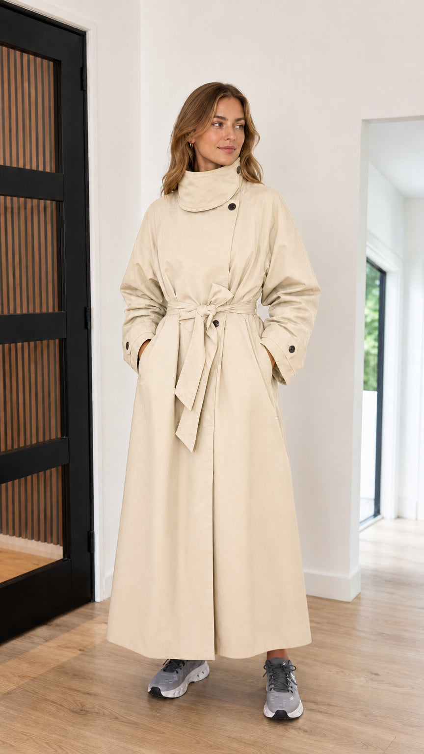 Front full-length view of cream high neck maxi trench coat