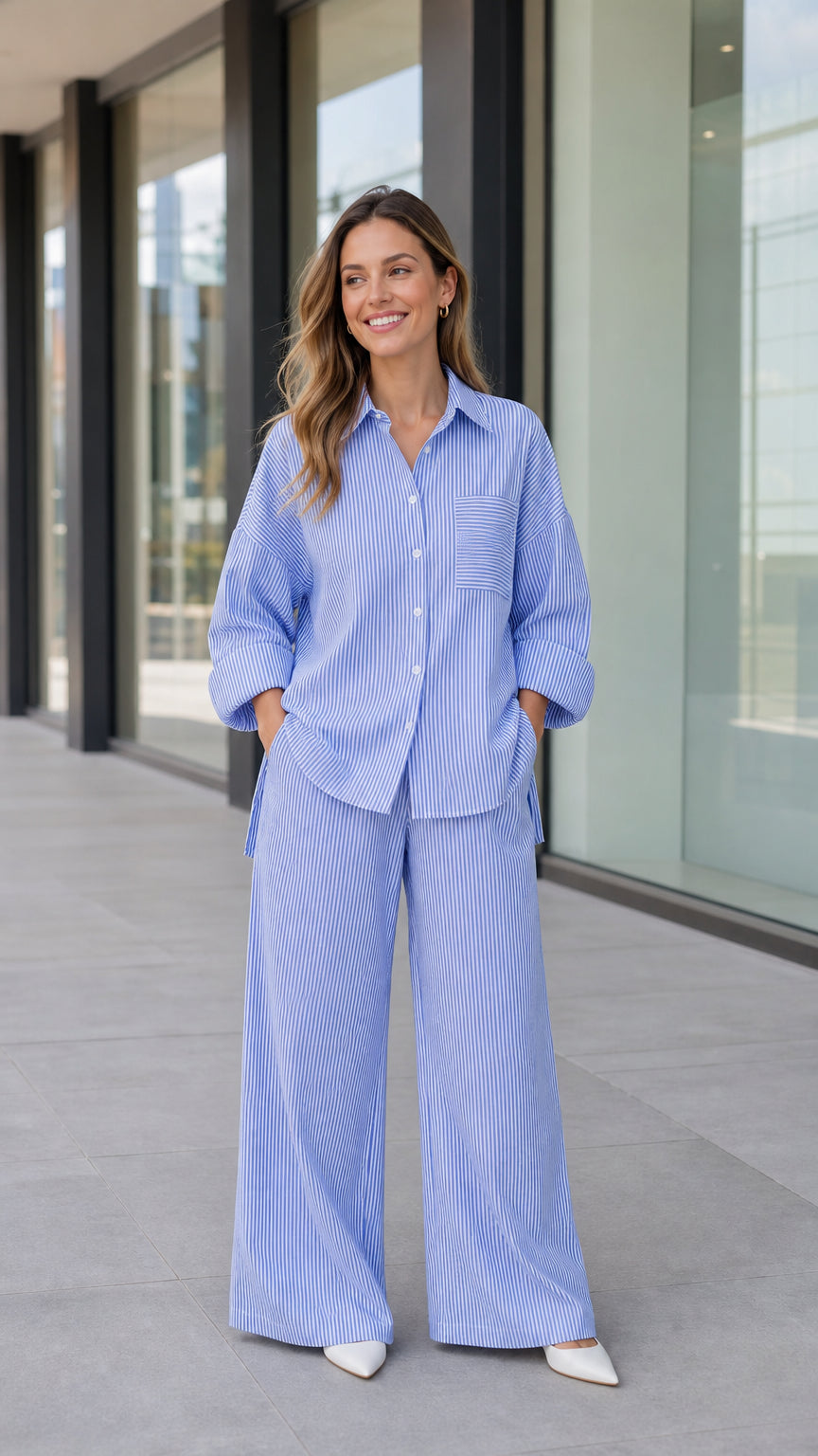 Front full-length view of woman wearing blue striped oversized button-down shirt and wide-leg pants set