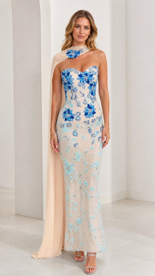 Front view of model wearing champagne floral beaded strapless evening gown with chiffon cape