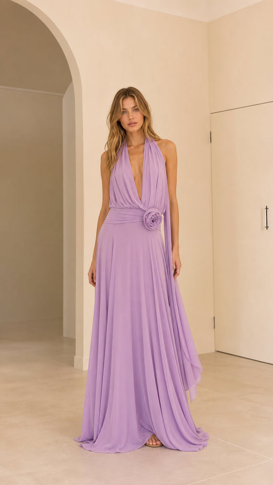 Front view of woman wearing lavender halter neck pleated maxi dress with rosette waist