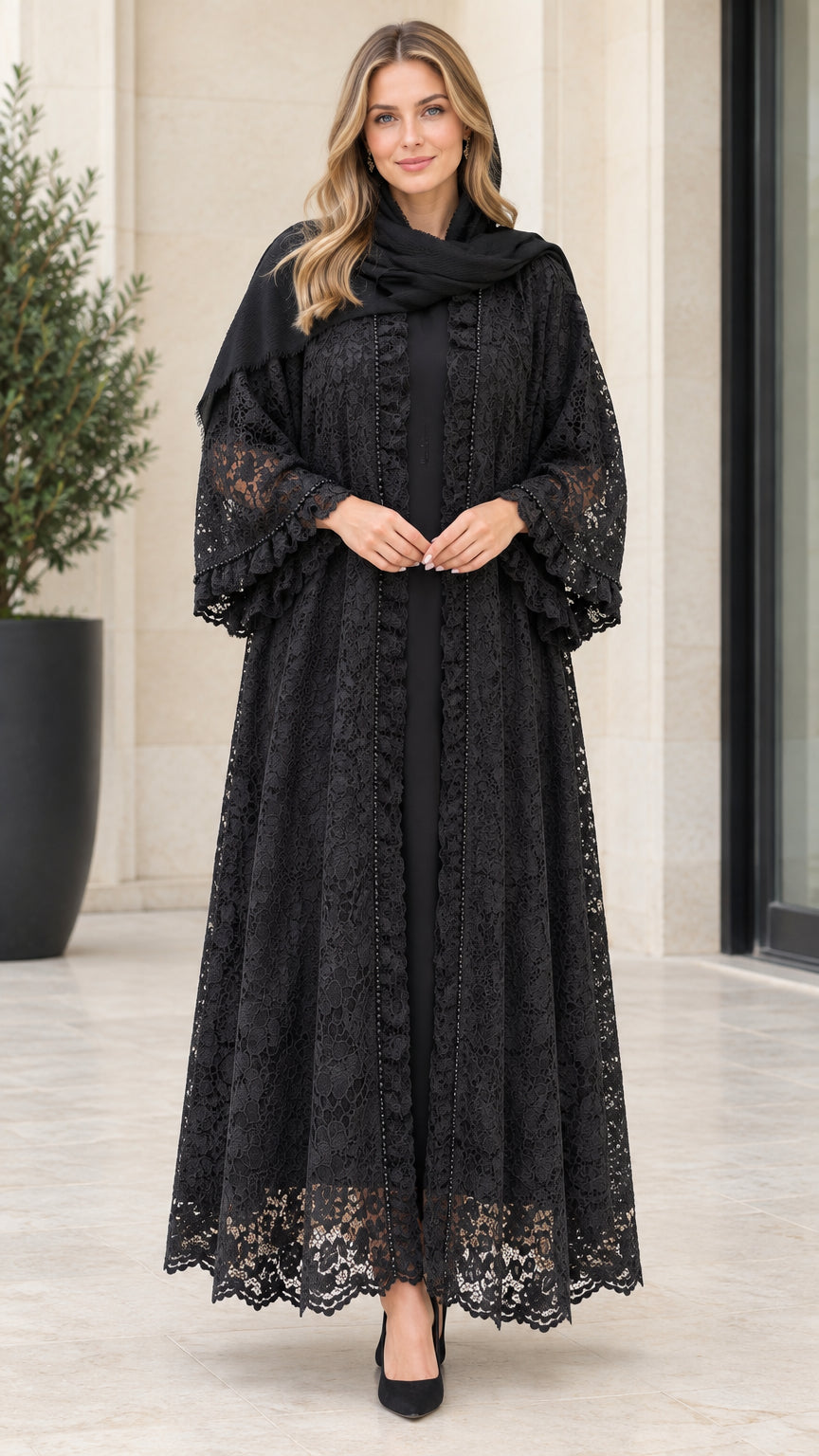 Front full-length view of woman wearing black floral lace maxi abaya with ruffle sleeves