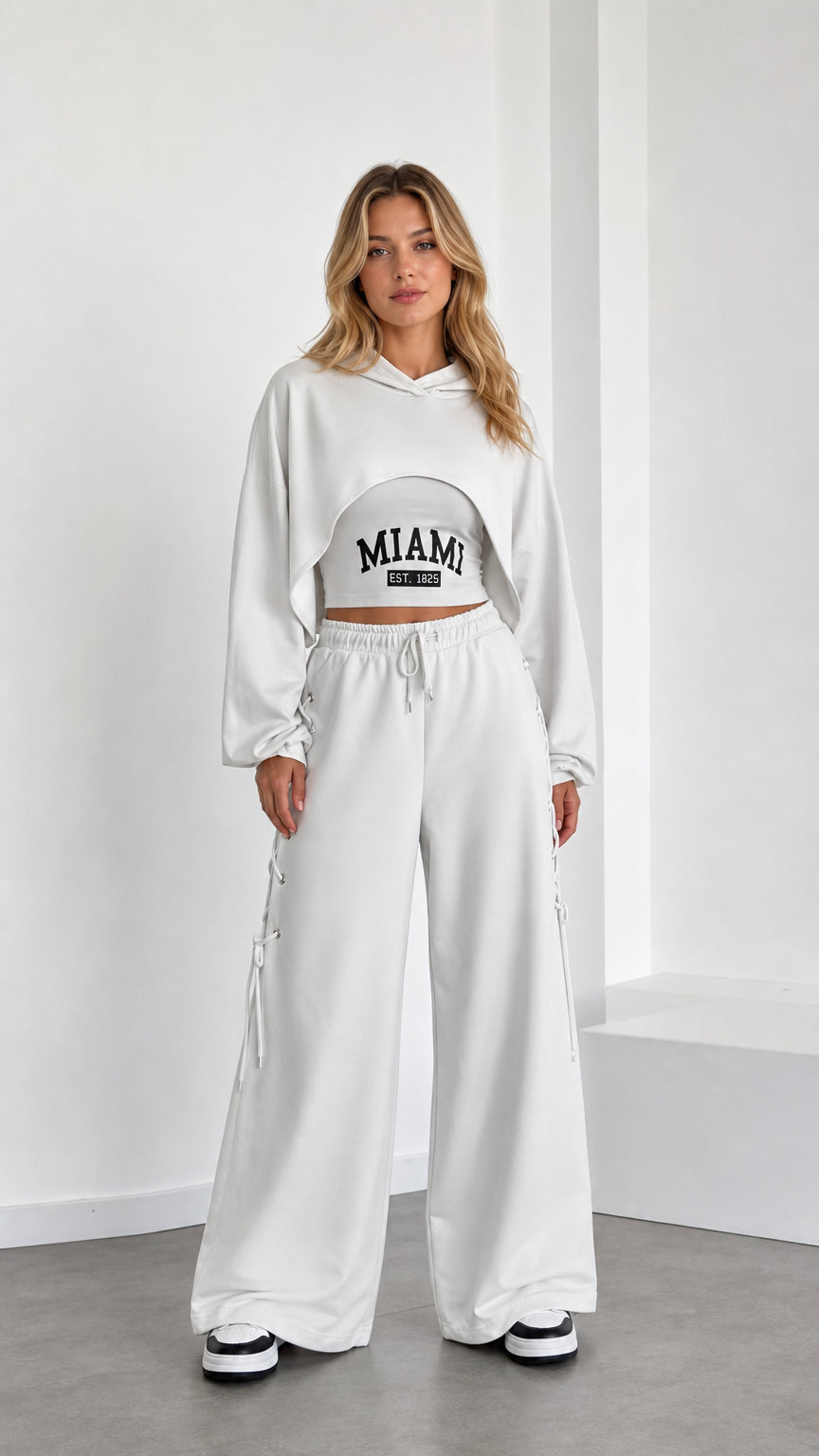 Front view of model wearing white 3-piece crop hoodie and wide leg sweatpants set