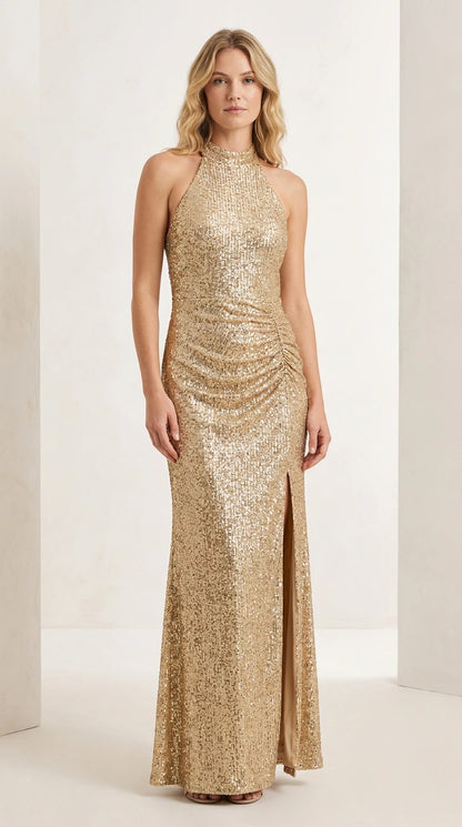 Front full-length view of model wearing the champagne gold halter sequin ruched evening maxi dress