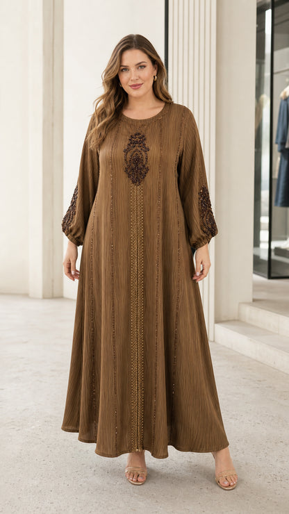 Front view of woman wearing brown crinkle-textured beaded maxi kaftan dress