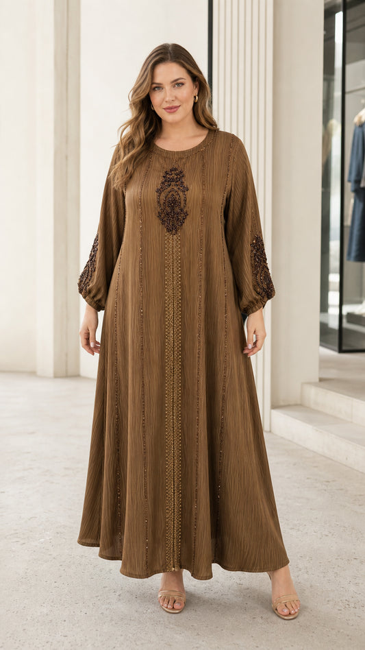 Front view of woman wearing brown crinkle-textured beaded maxi kaftan dress