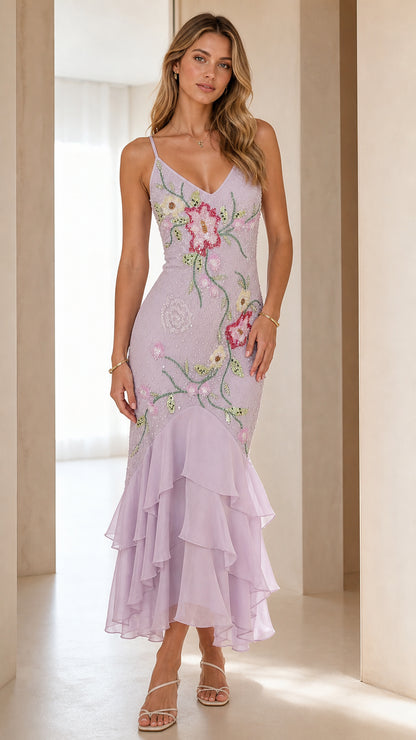 Front view of model wearing lavender floral embroidered beaded midi dress with tiered ruffle hem