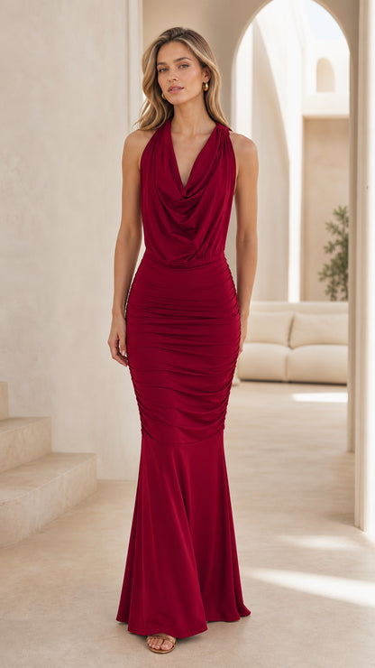 Front view of model wearing burgundy cowl neck halter mermaid maxi dress