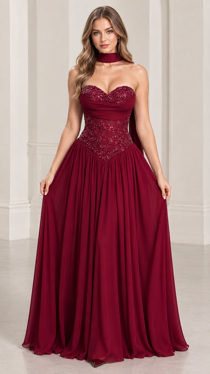 Front view of model wearing burgundy strapless beaded evening gown with neck scarf