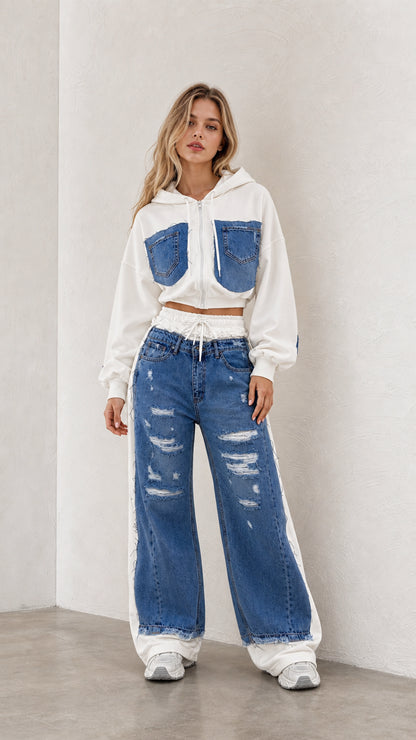 Front view of model wearing white cropped zip hoodie and blue denim spliced wide leg pants