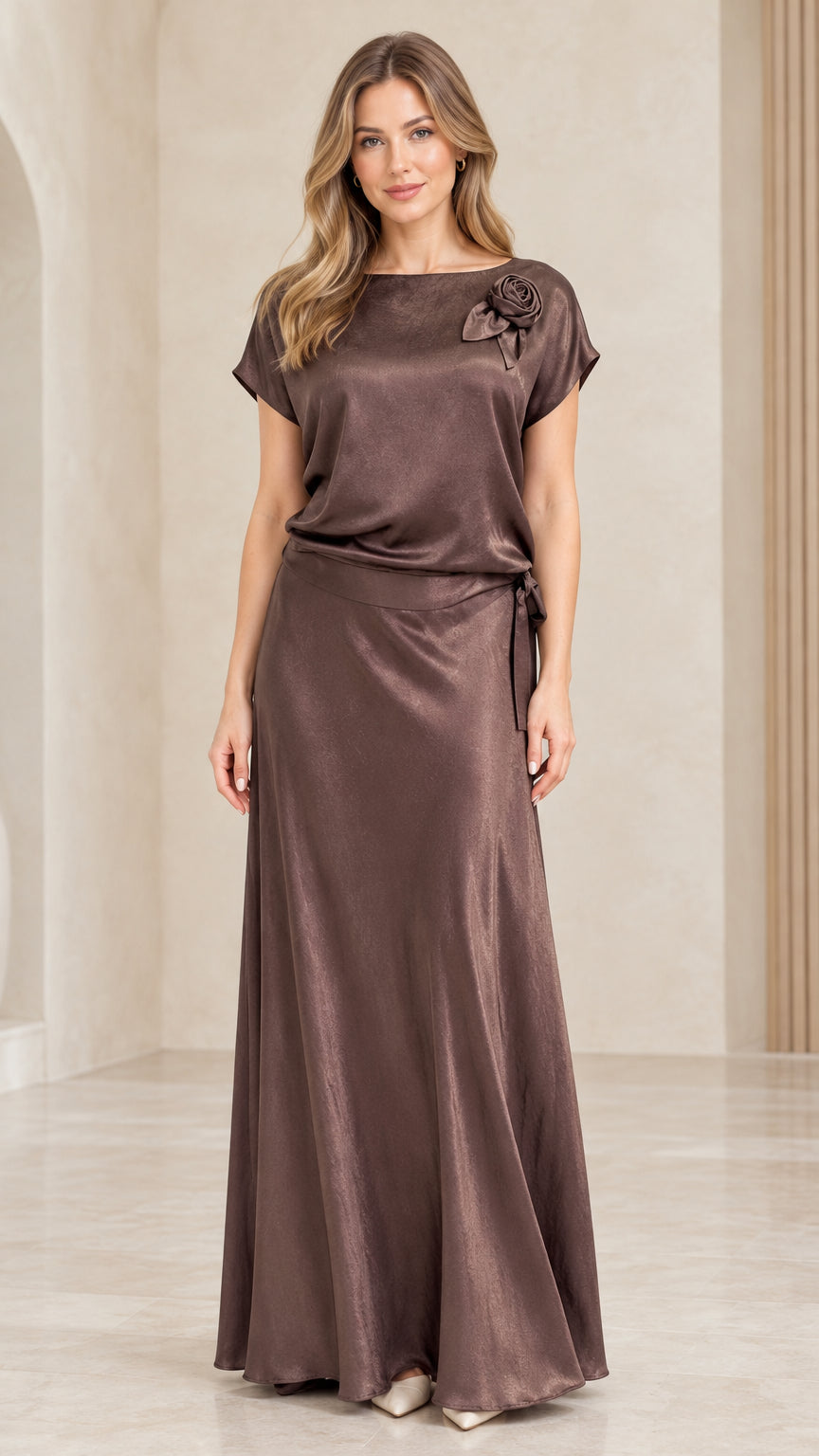 Front view of woman wearing Mocha Brown satin maxi dress with shoulder rosette detail