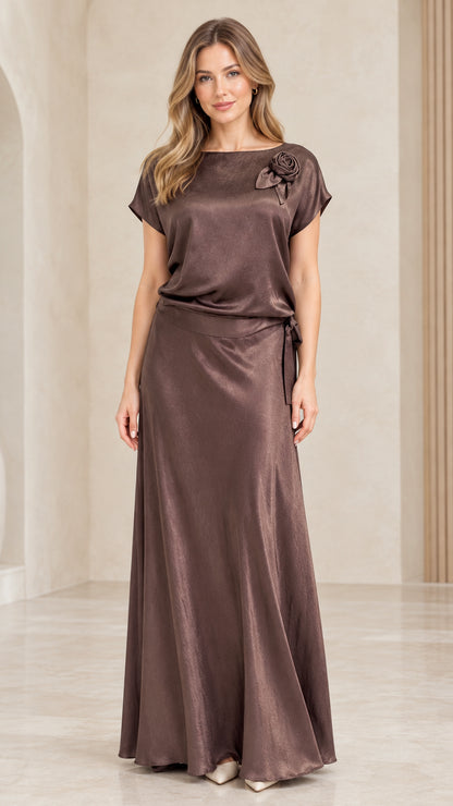 Front view of woman wearing Mocha Brown satin maxi dress with shoulder rosette detail