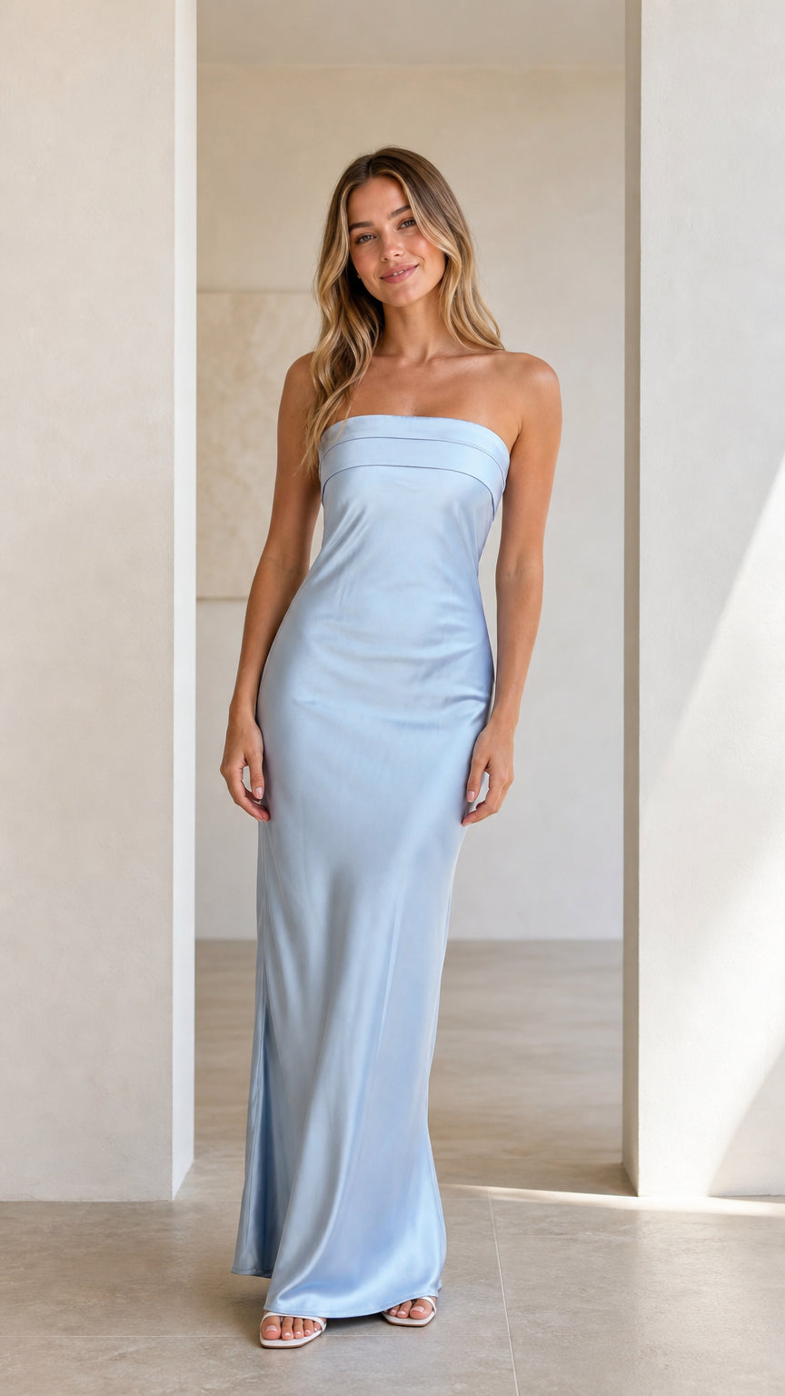 Front view of model wearing a light blue strapless satin maxi dress