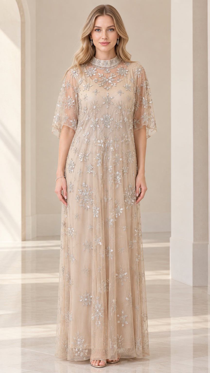Front full view of woman wearing champagne beaded mock neck maxi dress with flutter sleeves