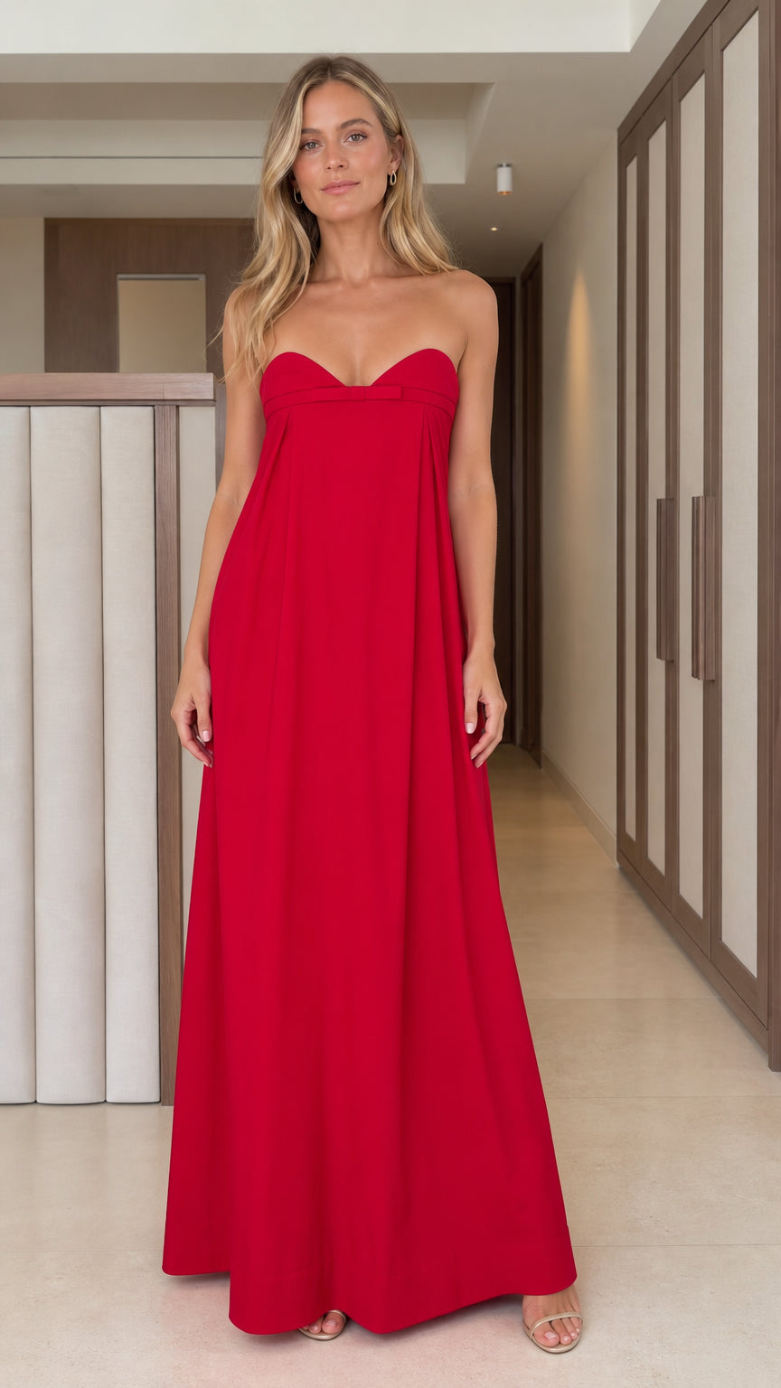 Front full view of woman wearing vibrant red strapless sweetheart maxi dress with bow detail