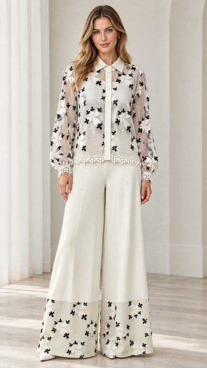 Model wearing white floral embroidered lace shirt and wide-leg pants set front view
