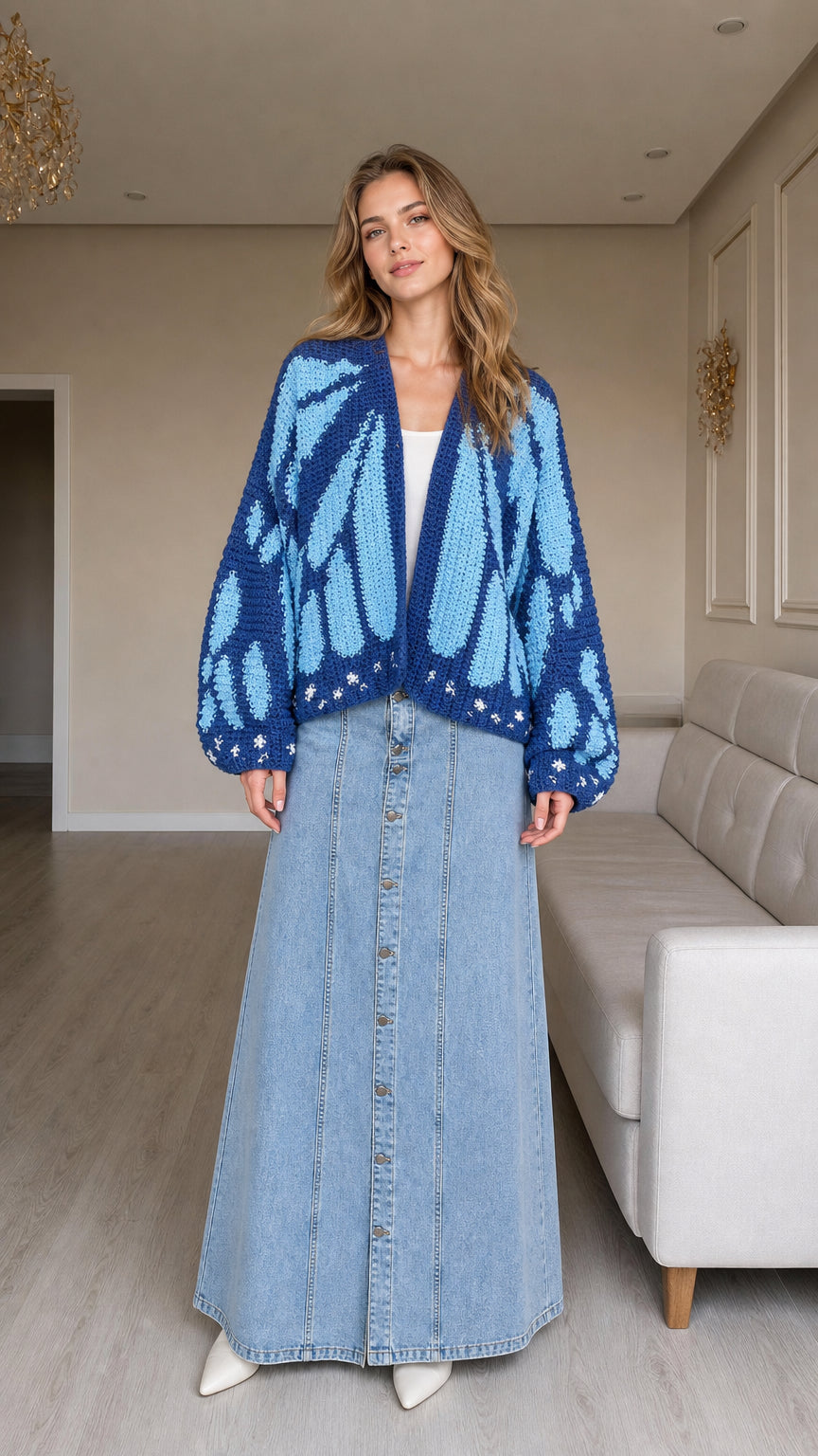 Front view of model wearing cobalt blue butterfly wing chunky knit cardigan with denim maxi skirt