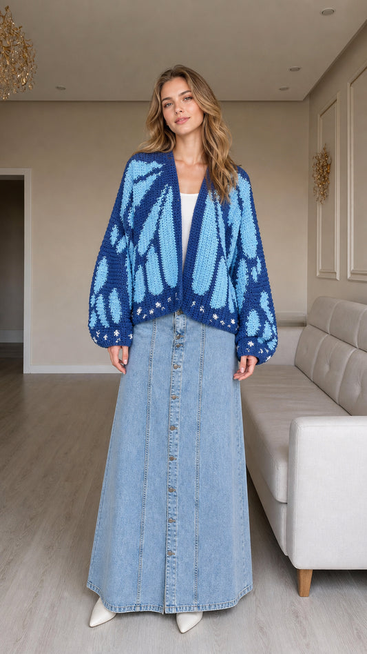 Front view of model wearing cobalt blue butterfly wing chunky knit cardigan with denim maxi skirt