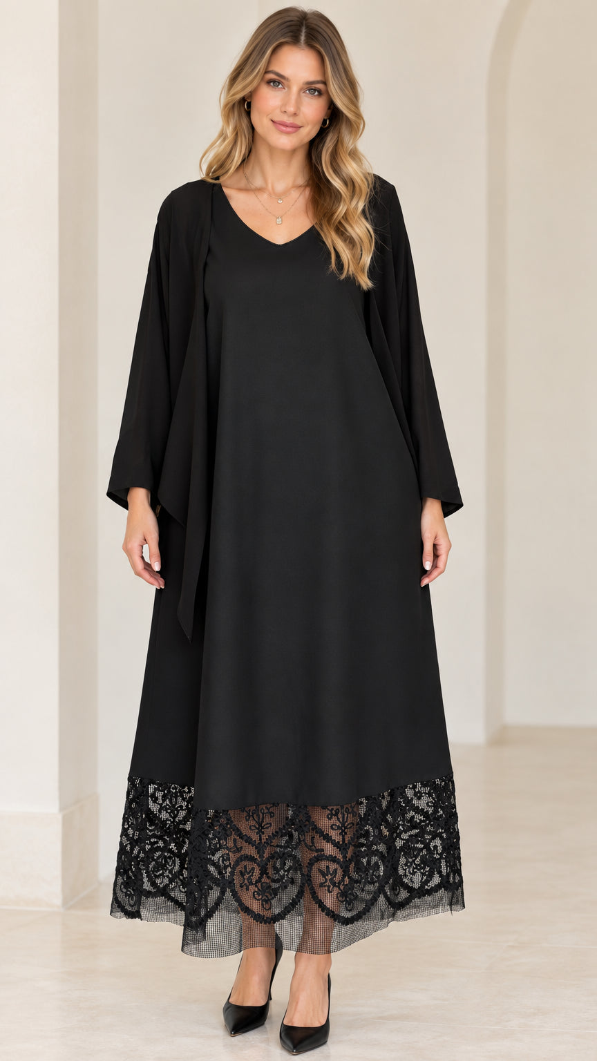 Front view of black V-neck maxi dress with sheer lace hem and draped cardigan overlay