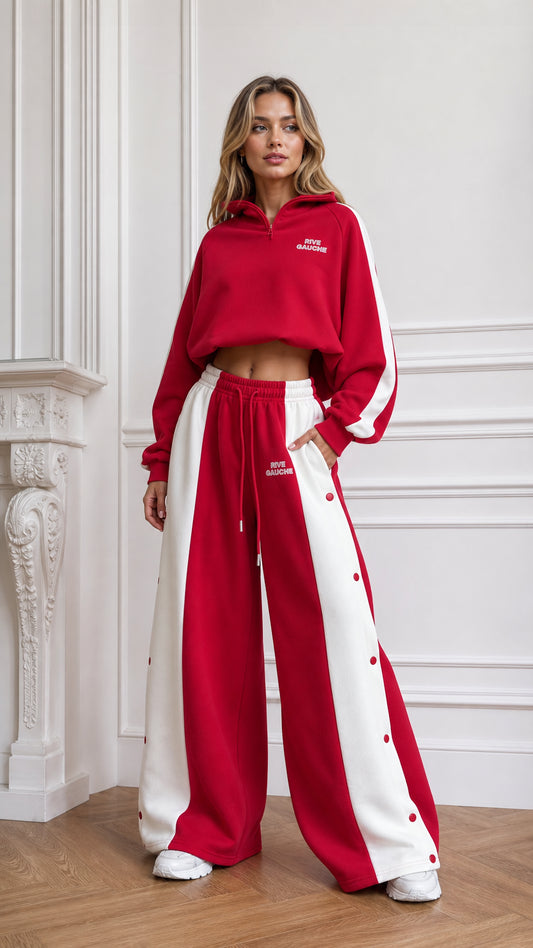 Front full view of woman wearing red cropped quarter-zip hoodie and wide-leg snap button track pants