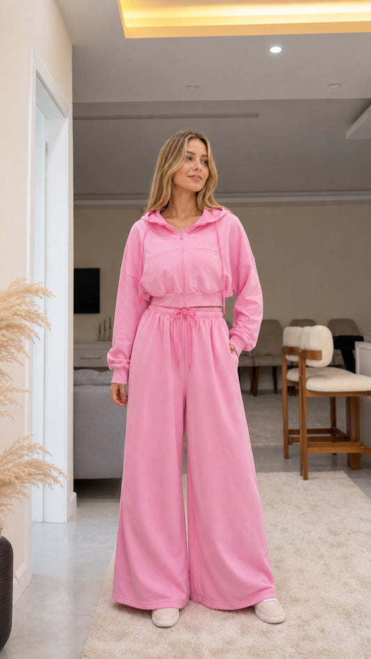 Full front view of model wearing pink cropped zip-up hoodie and wide-leg pants set