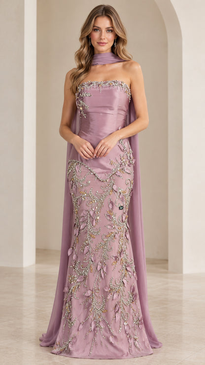 Front view of model wearing mauve strapless beaded mermaid evening gown with neck scarf cape