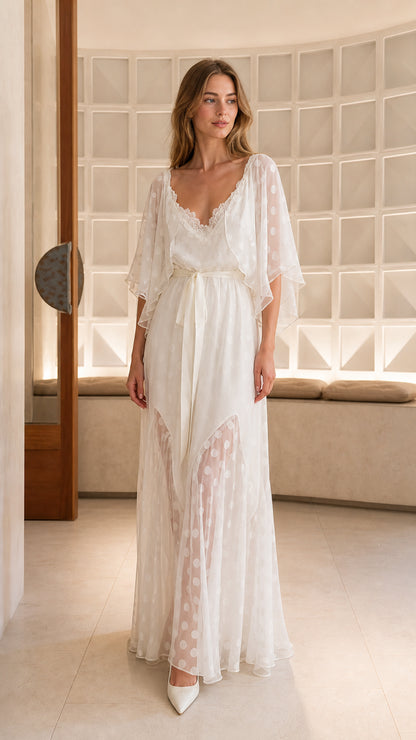 Front view of model wearing white polka dot lace trim flutter sleeve maxi dress