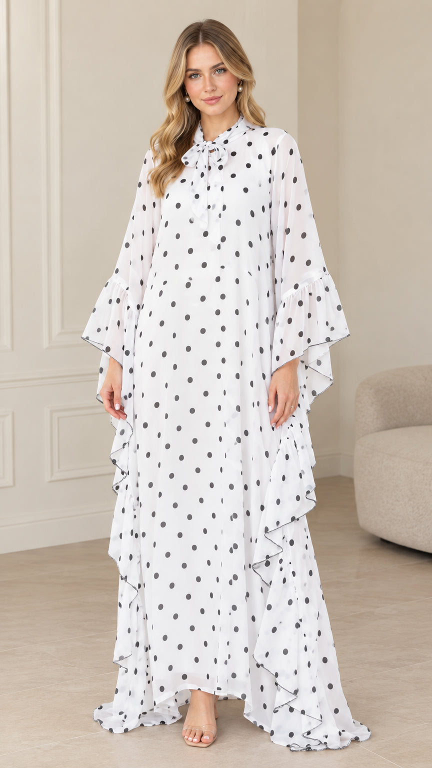 Front full view of white polka dot tie neck ruffle kaftan maxi dress