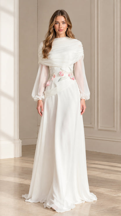 Front view of woman wearing white draped high neck long sleeve maxi dress with floral appliqué
