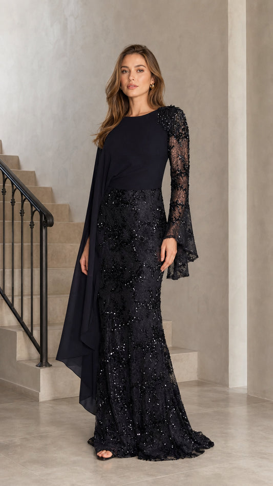 Model wearing black embellished cape sleeve sequin lace mermaid evening gown front view
