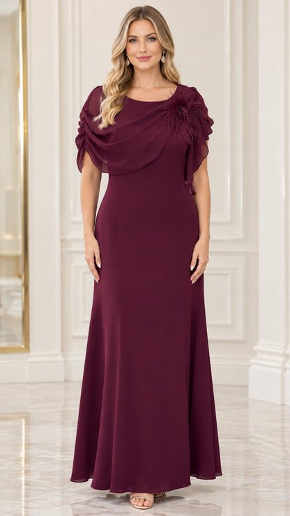 Front view of model wearing burgundy draped chiffon maxi evening dress with feather floral shoulder detail