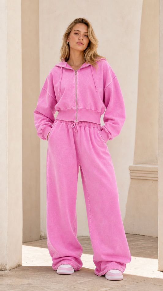 Full front view of model wearing washed pink cropped zip hoodie and wide leg sweatpants loungewear set