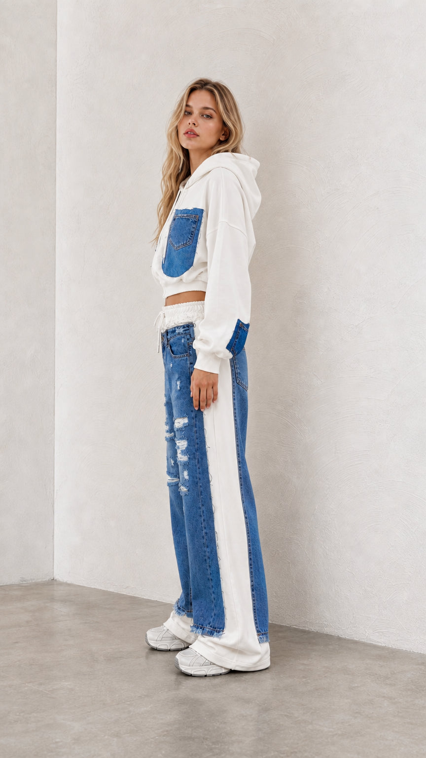 Side profile view of model wearing white denim patchwork cropped tracksuit set