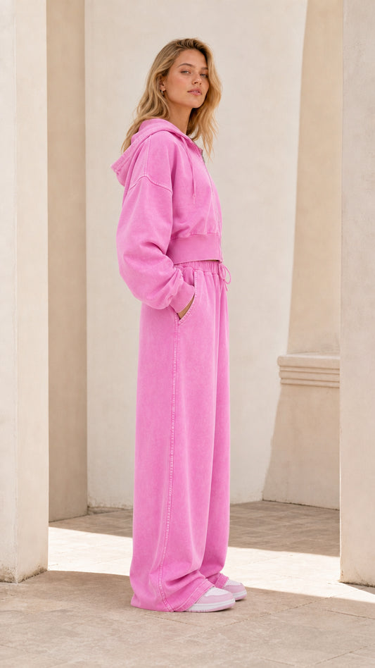 Side profile view of model wearing washed pink cropped hoodie and wide leg sweatpants