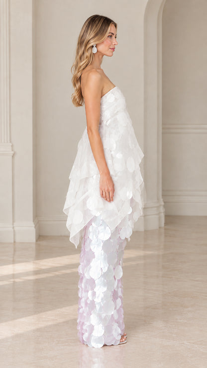 Side profile view of white tiered organza paillette evening dress