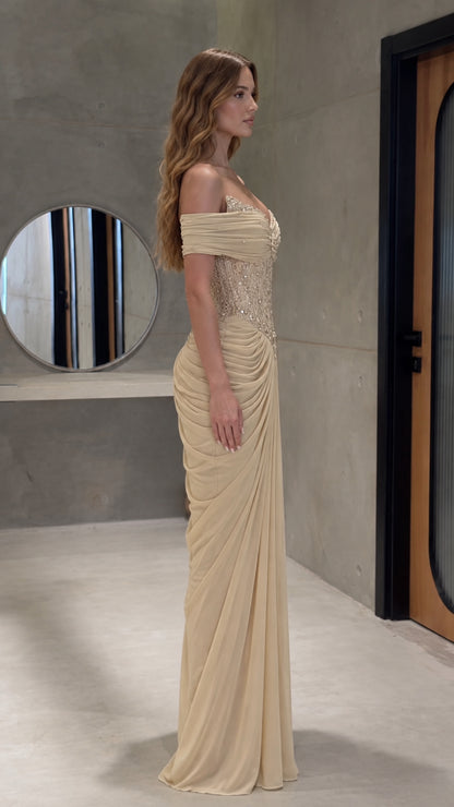 Side profile view of champagne draped corset evening dress