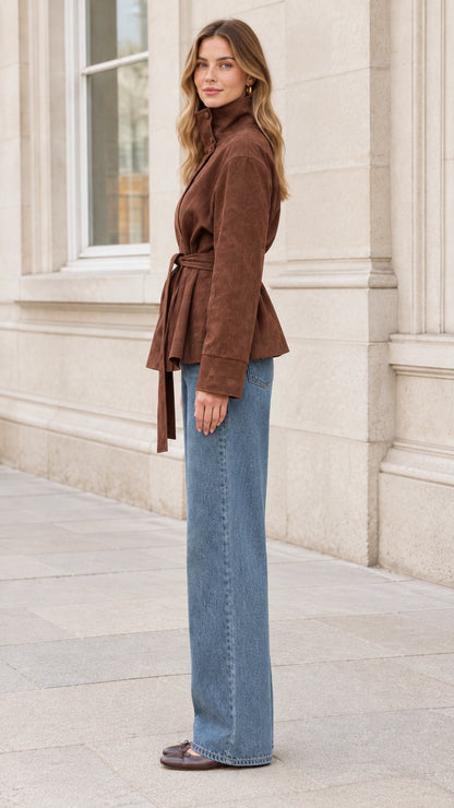 Side profile view of woman wearing brown tie waist faux suede jacket