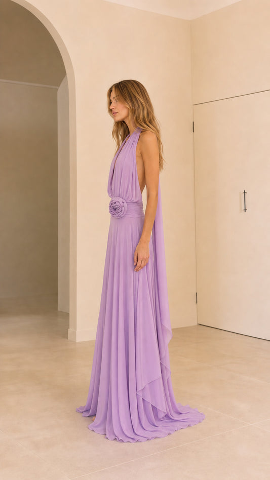 Side angle of lavender plunging halter gown showing drape and fluid silhouette
