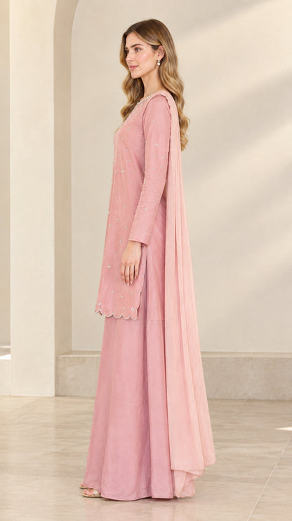 Side view of dusty rose long sleeve embroidered kurta and flowing palazzo pants