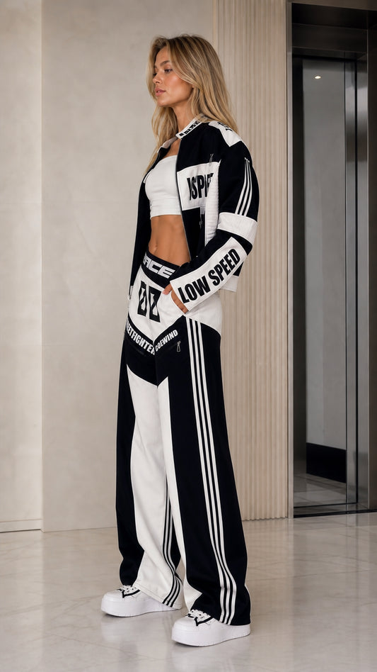 Side profile view of black and white racing tracksuit set with side striping