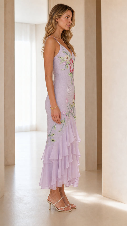 Side 3/4 view of lavender beaded mermaid midi dress showing elegant silhouette and drape