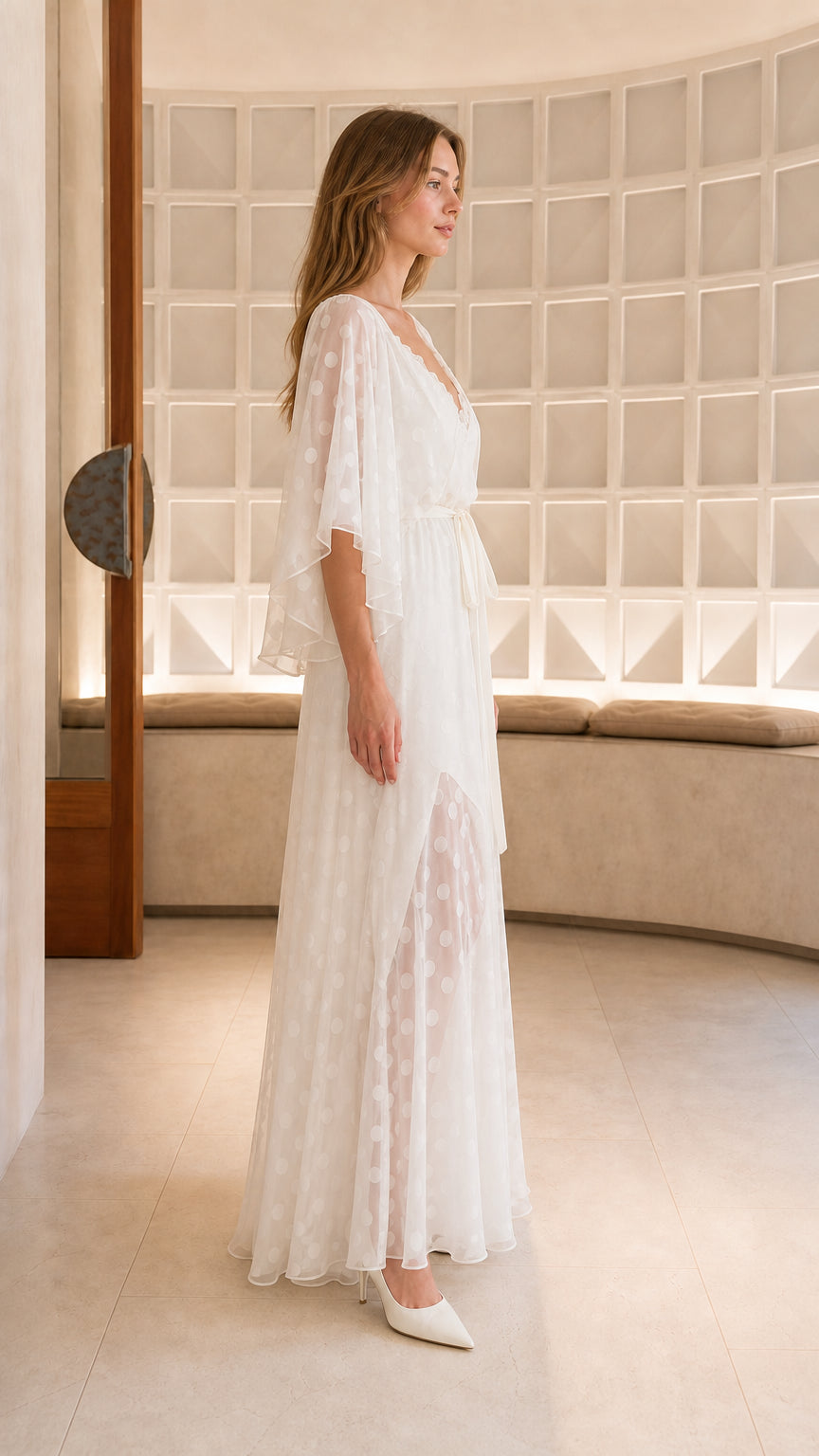 Side view of white polka dot sheer overlay maxi dress with tie waist