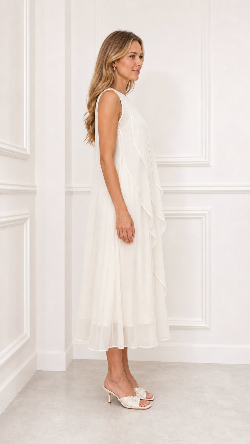 Side profile view of ivory sleeveless tiered ruffle midi dress
