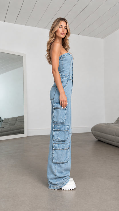 Side profile view of Light Blue strapless denim jumpsuit showing leg cargo flap pockets