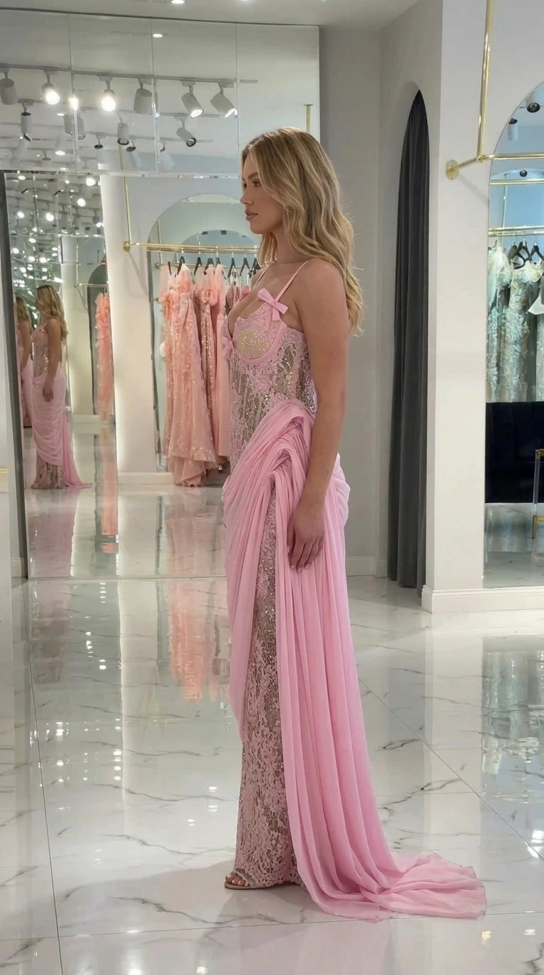 Side profile view of light pink formal gown showing cascading side train