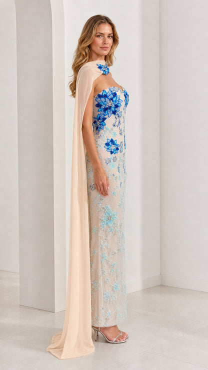 Side profile of champagne beaded sweetheart maxi dress with flowing shoulder drape